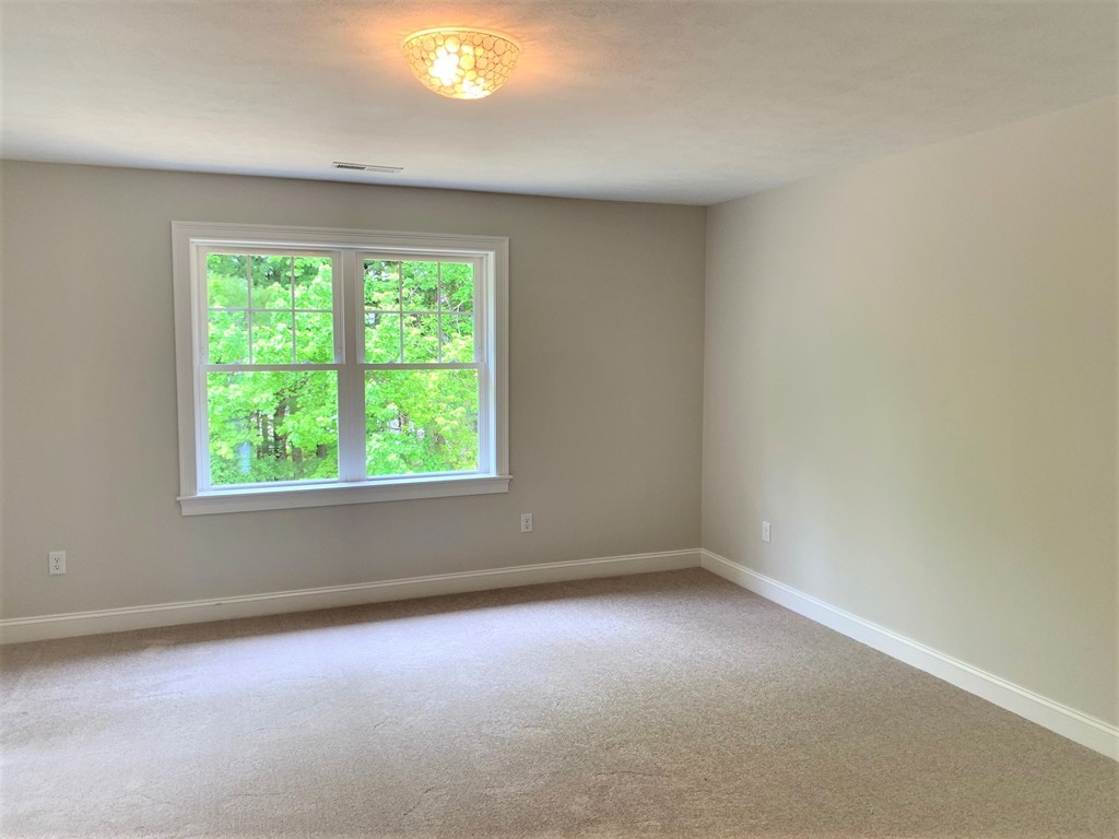 25 Shaker Road, Unit B Ayer, MA 01432 - Photo 7 of 16 an empty room with a window