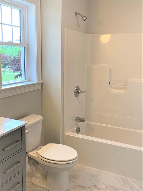 25 Shaker Road, Unit B Ayer, MA 01432 - Photo 10 of 16 a bathroom with a toilet a sink and a bathtub