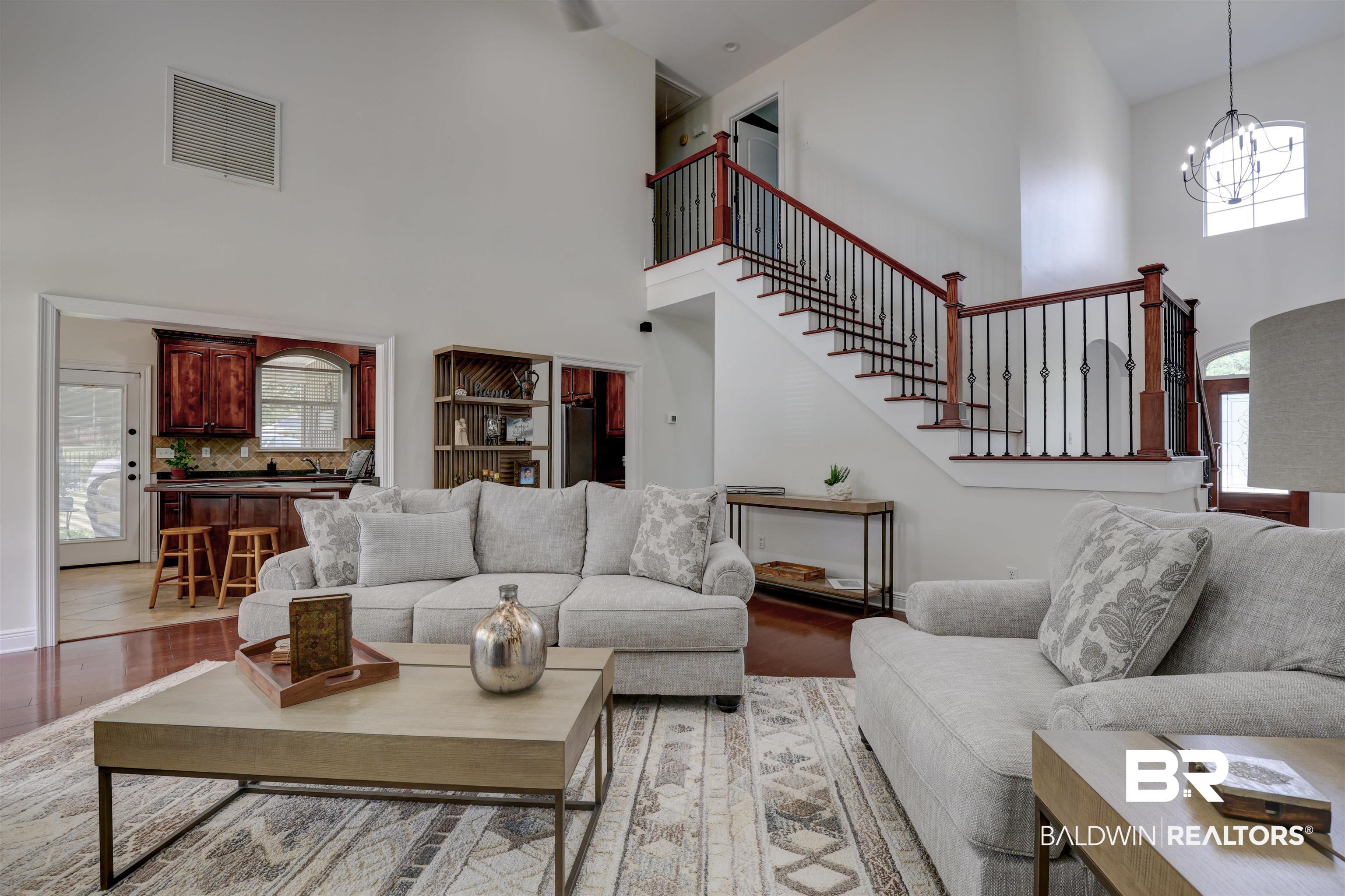 5565 Dawes Lane Theodore, AL 36582 - Photo 6 of 38 Living room with high vaulted ceiling, an inviting chandelier, and light hardwood / wood-style flooring