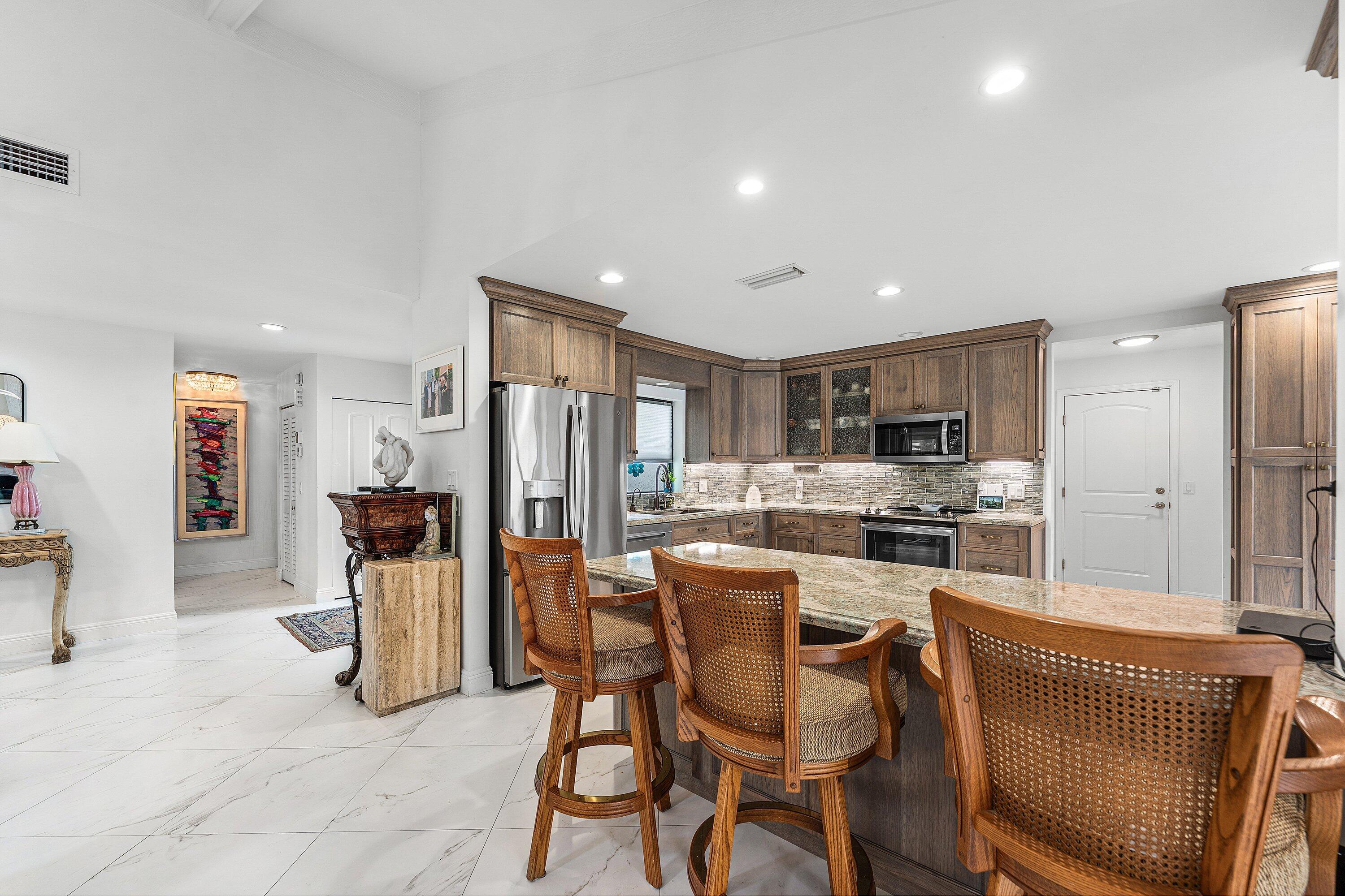 35 Woods Lane Boynton Beach, FL 33436 - Photo 11 of 82 a dining room with furniture and a kitchen view