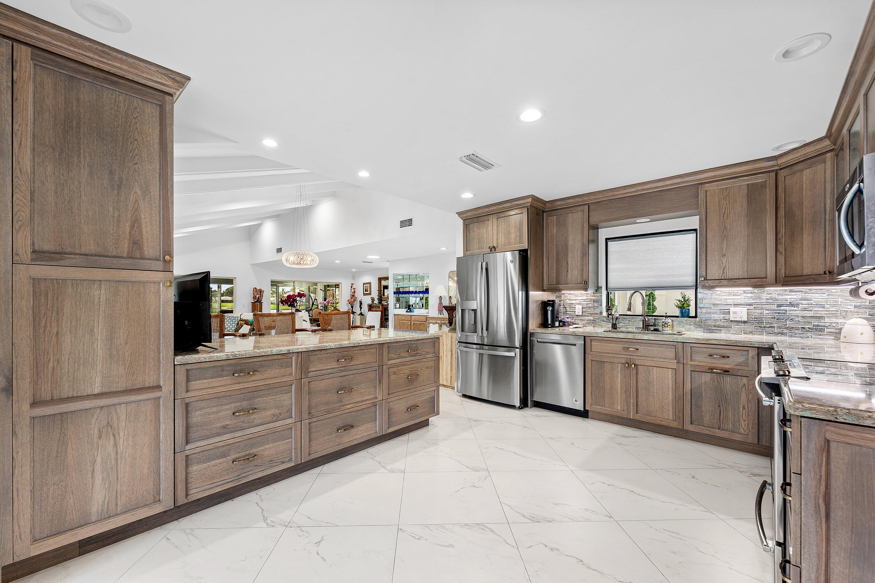 35 Woods Lane Boynton Beach, FL 33436 - Photo 12 of 82 a kitchen with granite countertop cabinets and stainless steel appliances