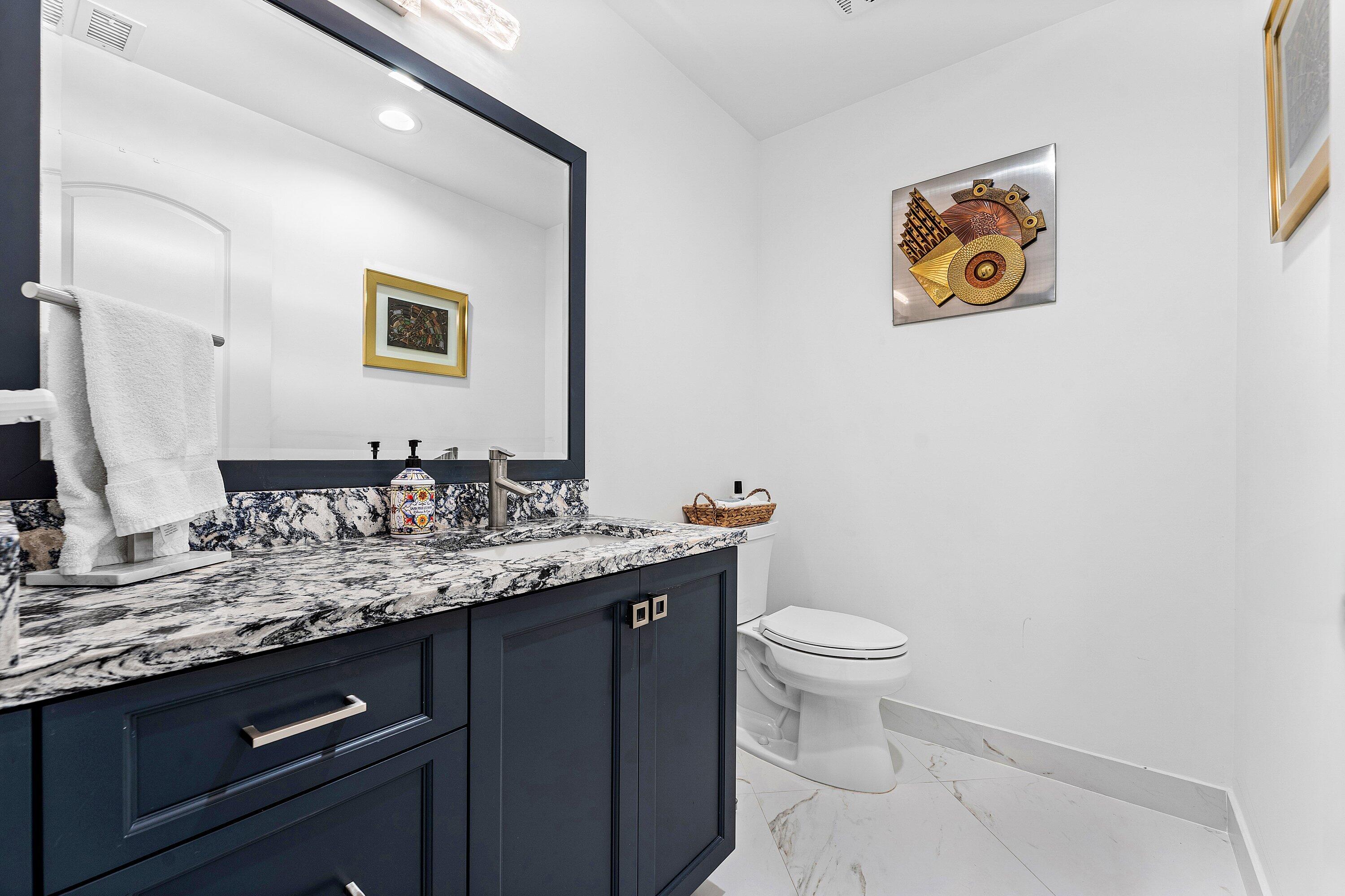 35 Woods Lane Boynton Beach, FL 33436 - Photo 24 of 82 a bathroom with a granite countertop sink mirror and toilet