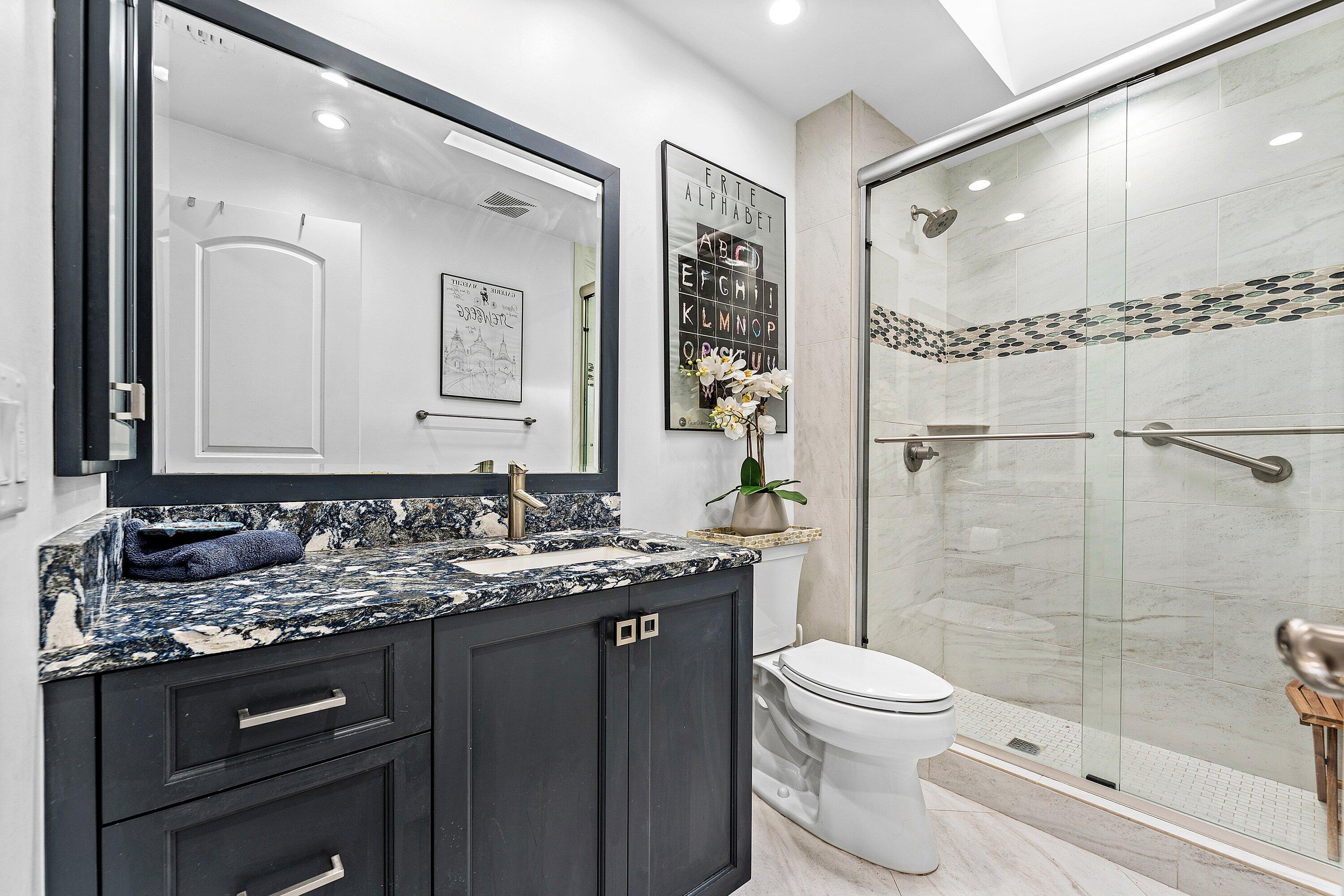 35 Woods Lane Boynton Beach, FL 33436 - Photo 32 of 82 a bathroom with a granite countertop sink toilet and shower