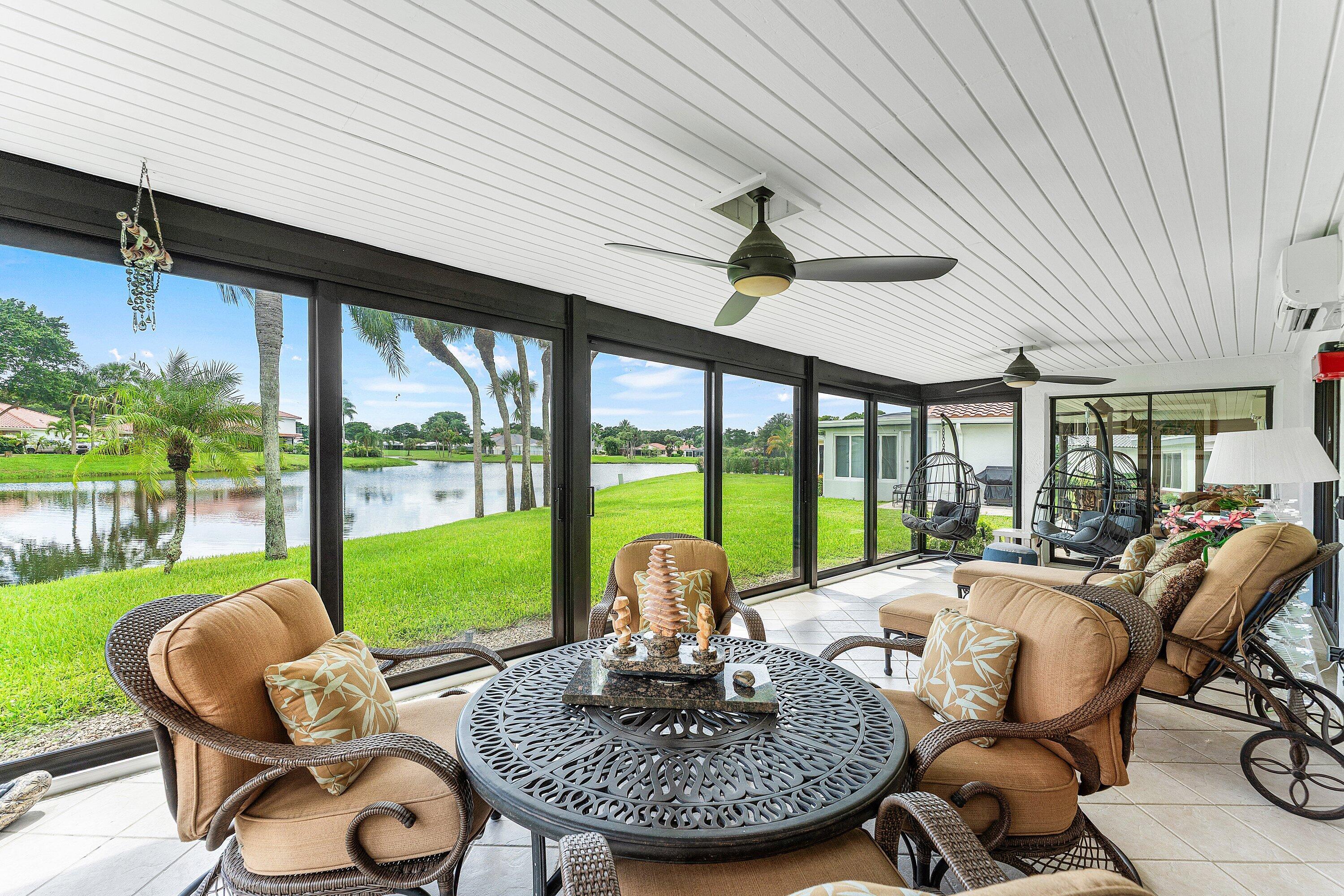 35 Woods Lane Boynton Beach, FL 33436 - Photo 36 of 82 a living room with furniture and a floor to ceiling window