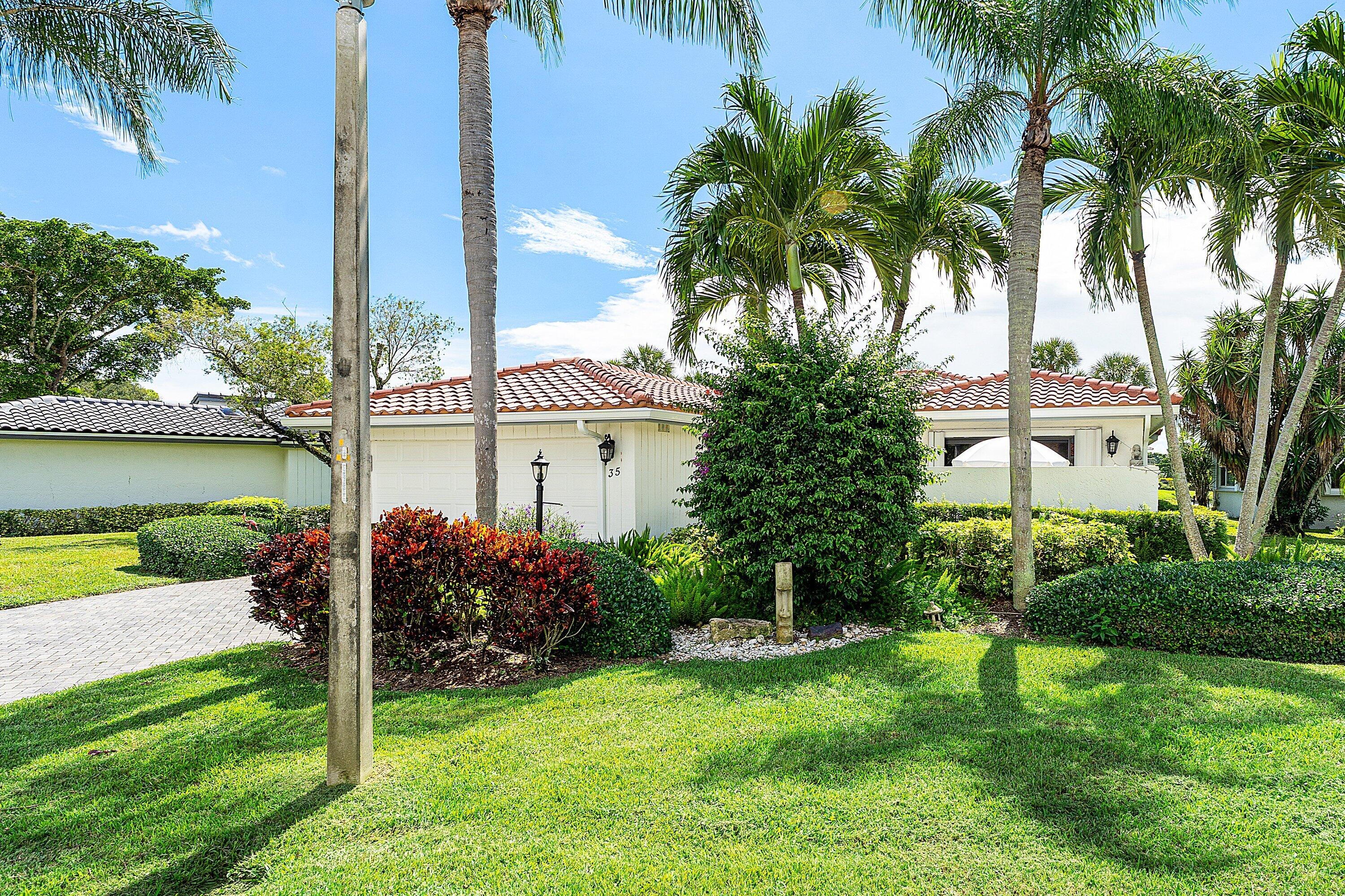 35 Woods Lane Boynton Beach, FL 33436 - Photo 5 of 82 a view of a house with a yard and palm trees