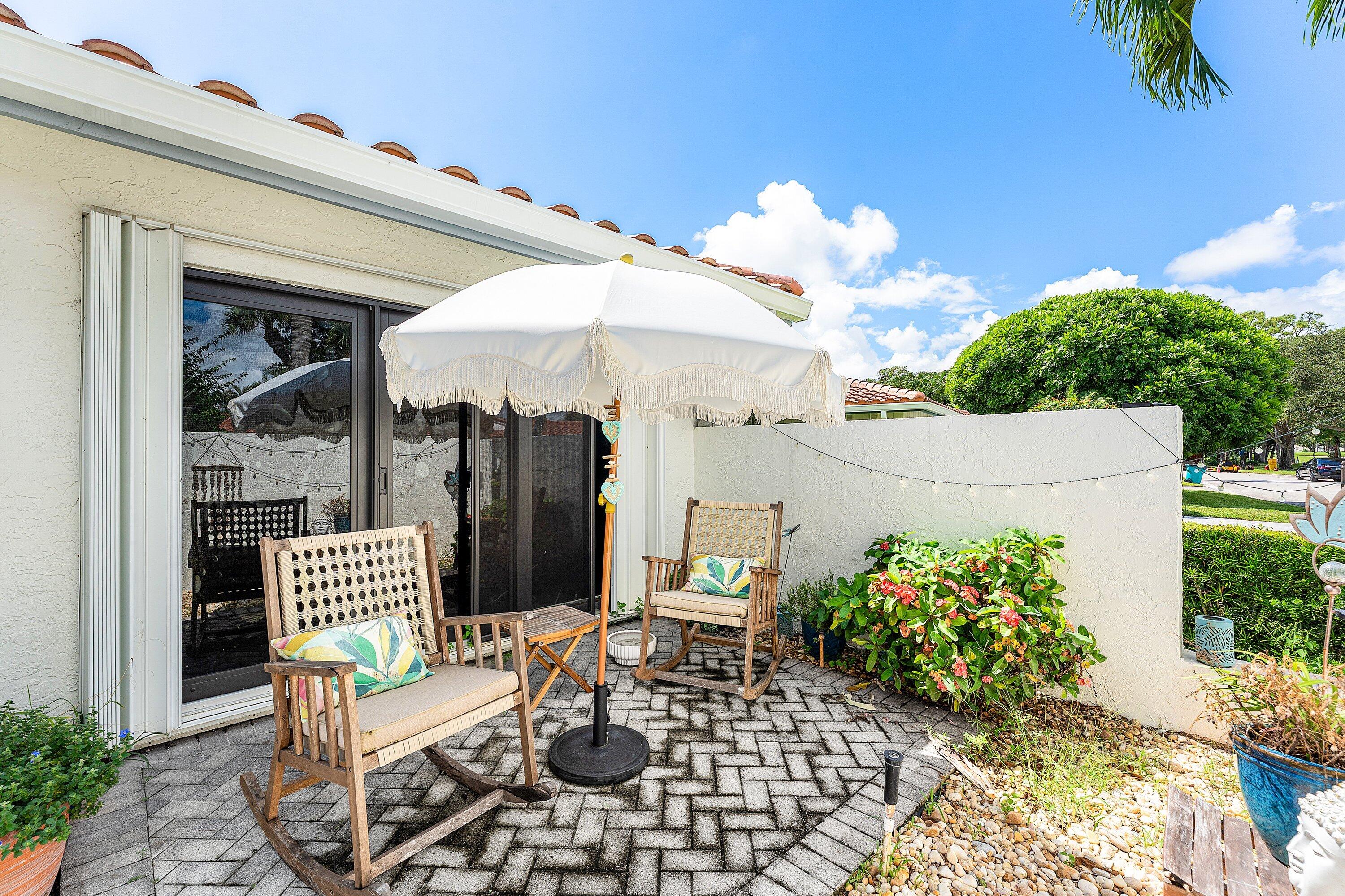 35 Woods Lane Boynton Beach, FL 33436 - Photo 7 of 82 a view of a patio with a table and chairs
