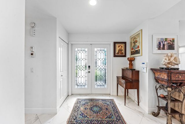 a dining room with furniture and a kitchen view