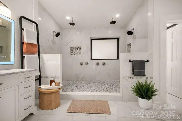 a bathroom with a potted plant and a shower