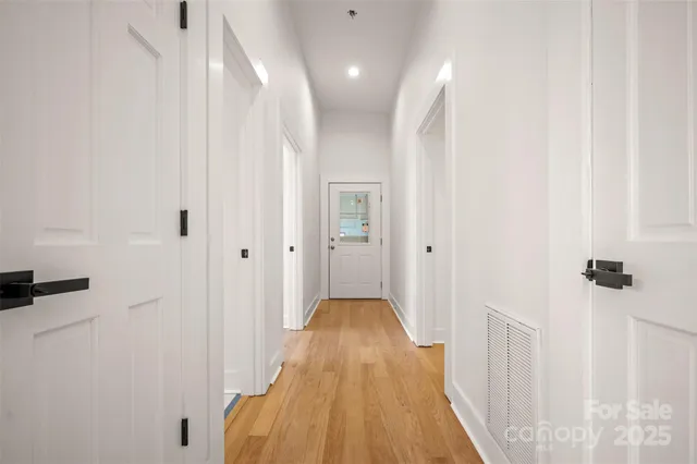 a view of hallway with wooden floor