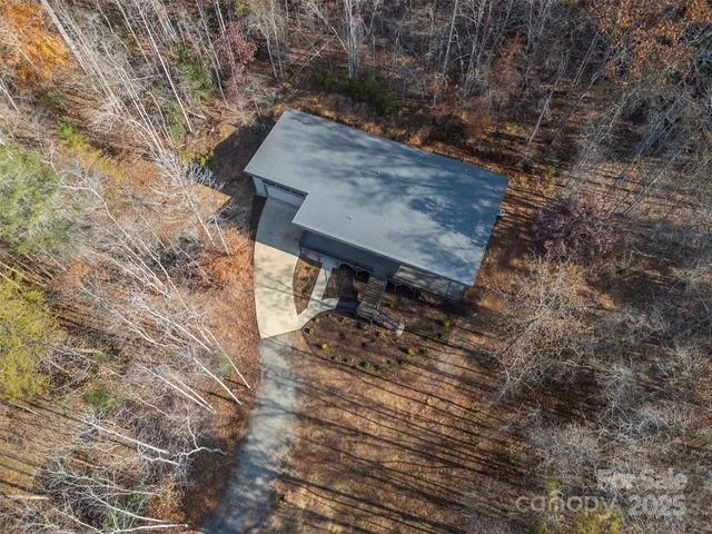 a view of a dry yard with lots of bushes