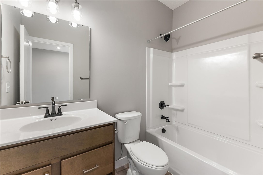 407 South Landon Lane Springfield, OH 45502 - Photo 18 of 30 This functional bathroom features a single vanity, modern fixtures, and a combined shower-tub unit.