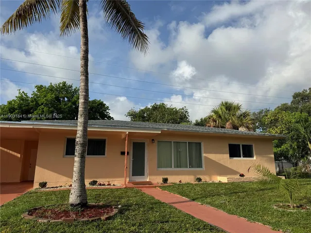 a front view of a house with garden and yard