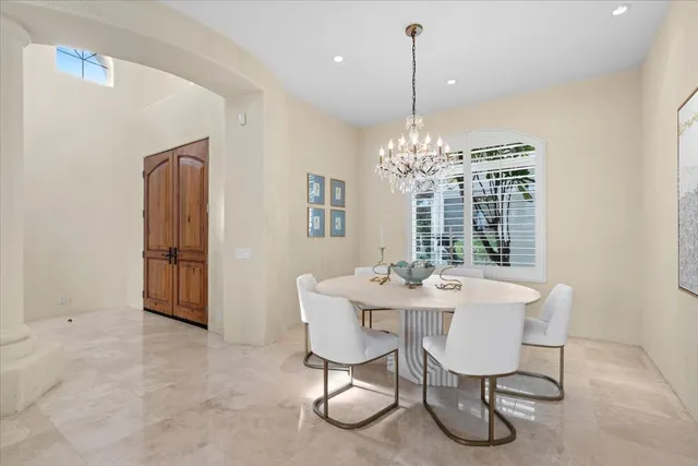 a view of a dining room with furniture and chandelier
