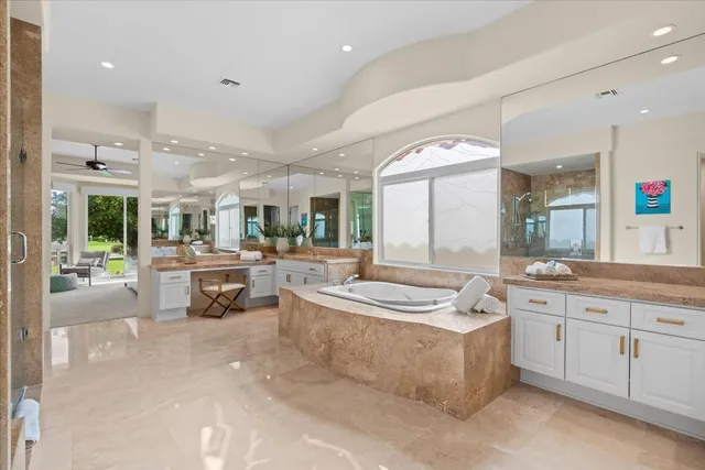 a large white kitchen with a large window