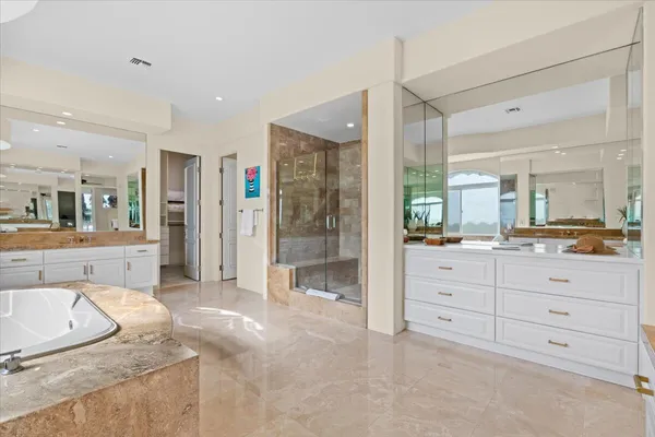 a spacious bathroom with a granite countertop sink mirror and shower
