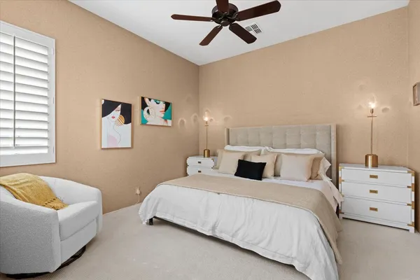 a bedroom with a bed and couch