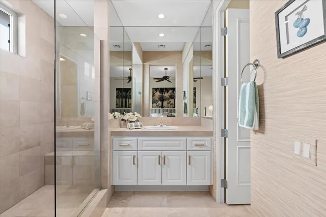 a bathroom with a granite countertop sink shower and a mirror