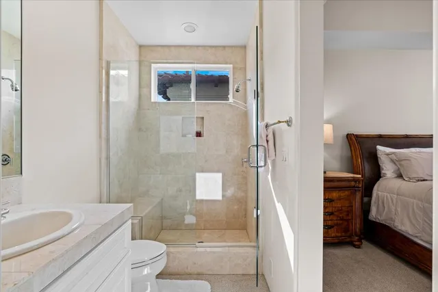 a bathroom with a toilet a sink and shower