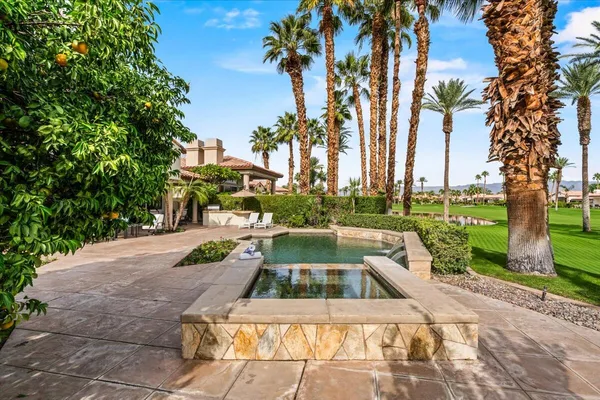 a view of a patio with couches and a fire pit