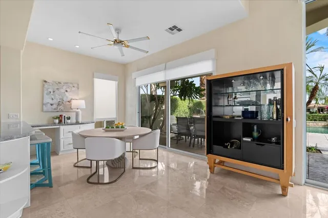a living room with furniture a chandelier and a window