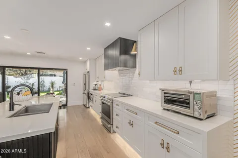 a kitchen with a stove a sink and a refrigerator