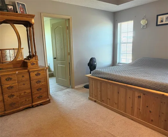 a bed room with a bed and a dresser