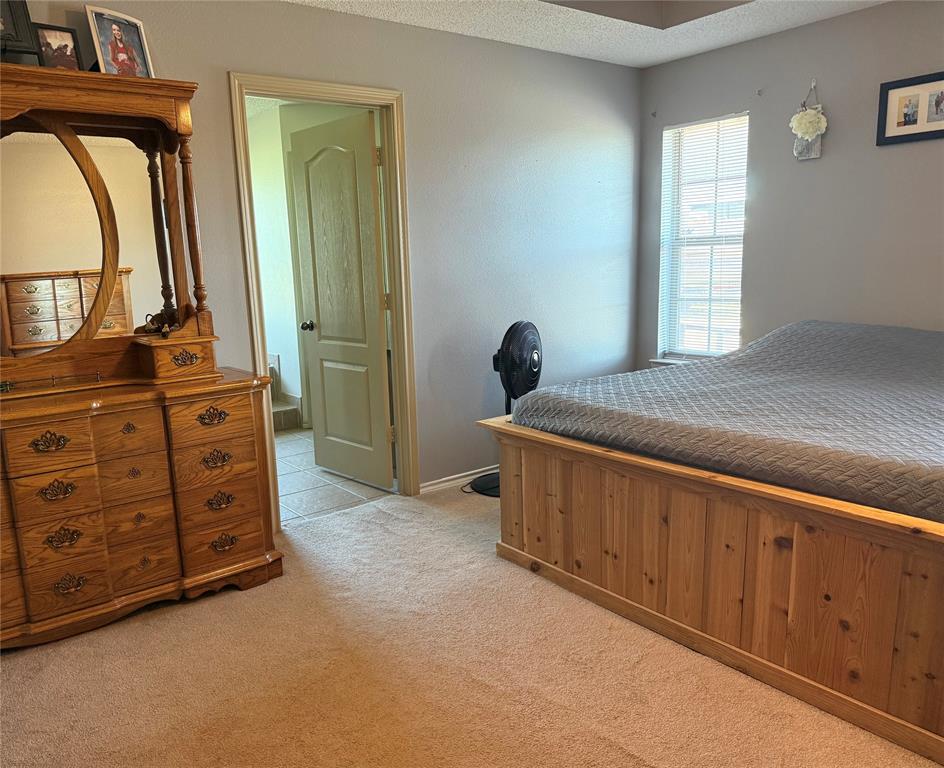 240 County Road Paris, TX 75462 - Photo 11 of 25 a bed room with a bed and a dresser