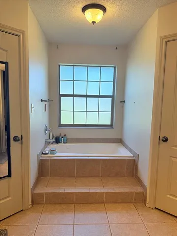 a spacious bathroom with a tub and a shower