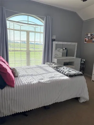 a bedroom with a bed and window