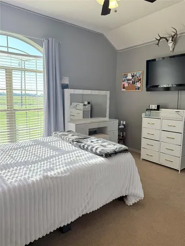 a bedroom with a bed and flat screen tv