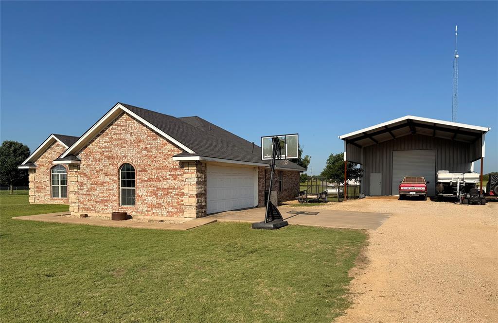 240 County Road Paris, TX 75462 - Photo 4 of 25 a view of a house with backyard and porch