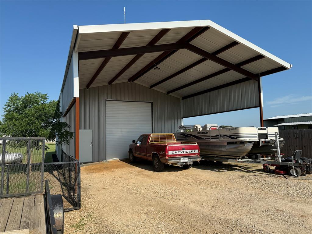 240 County Road Paris, TX 75462 - Photo 5 of 25 a car parked in front of garage