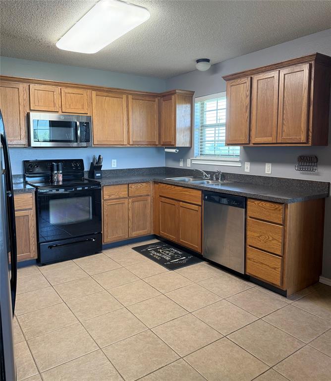 240 County Road Paris, TX 75462 - Photo 9 of 25 a kitchen with stainless steel appliances granite countertop a stove sink and cabinets