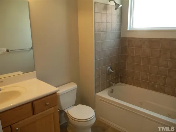 a white bath tub sitting next to a white toilet