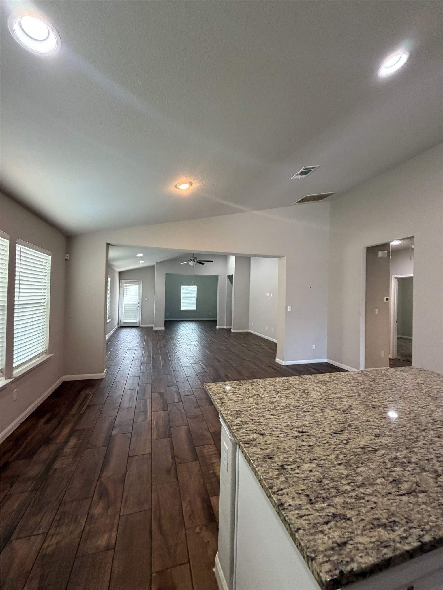 248 Falling Star Lane Georgetown, TX 78628 - Photo 16 of 16 An open floorplan features beautiful wood-look tile flooring and recessed lighting.