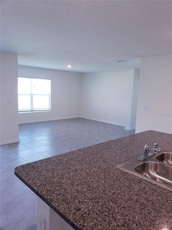 12211 Kingsley Trail Parrish, FL 34219 - Photo 16 of 28 an empty room with a natural light