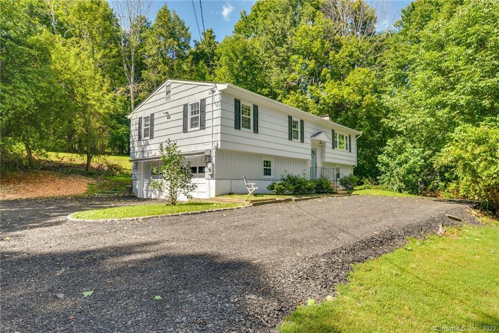 315 Danbury Road Ridgefield, CT 06877 - Photo 1 of 1 a front view of a house with a yard and garage