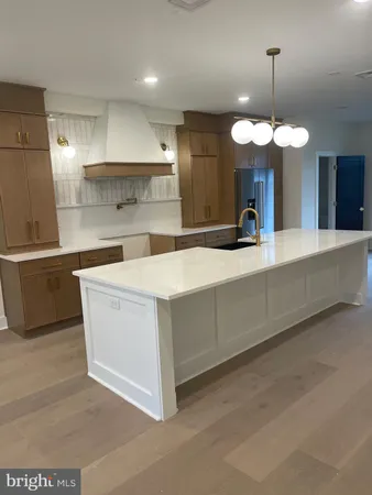 a view of a kitchen with a sink and chandelier