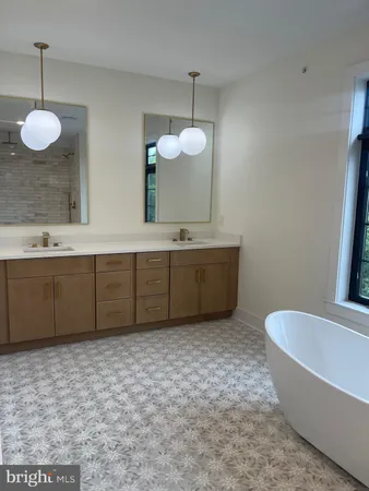 a bathroom with a tub sink and mirror