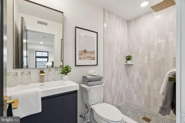 a bathroom with a sink toilet and shower