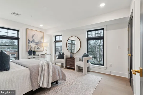 a living room with furniture a large window and a chandelier