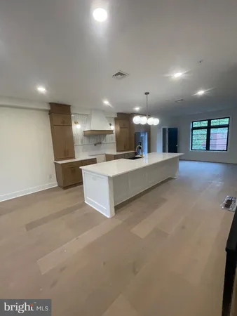 a large kitchen with a sink and white cabinets