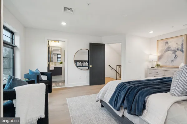 a bedroom with a bed and dresser