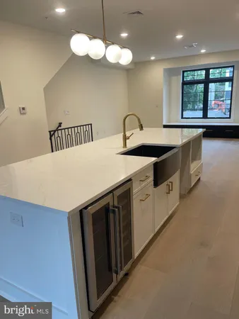 a kitchen that has a sink a stove and a window