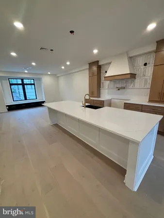 a large white kitchen with a large window