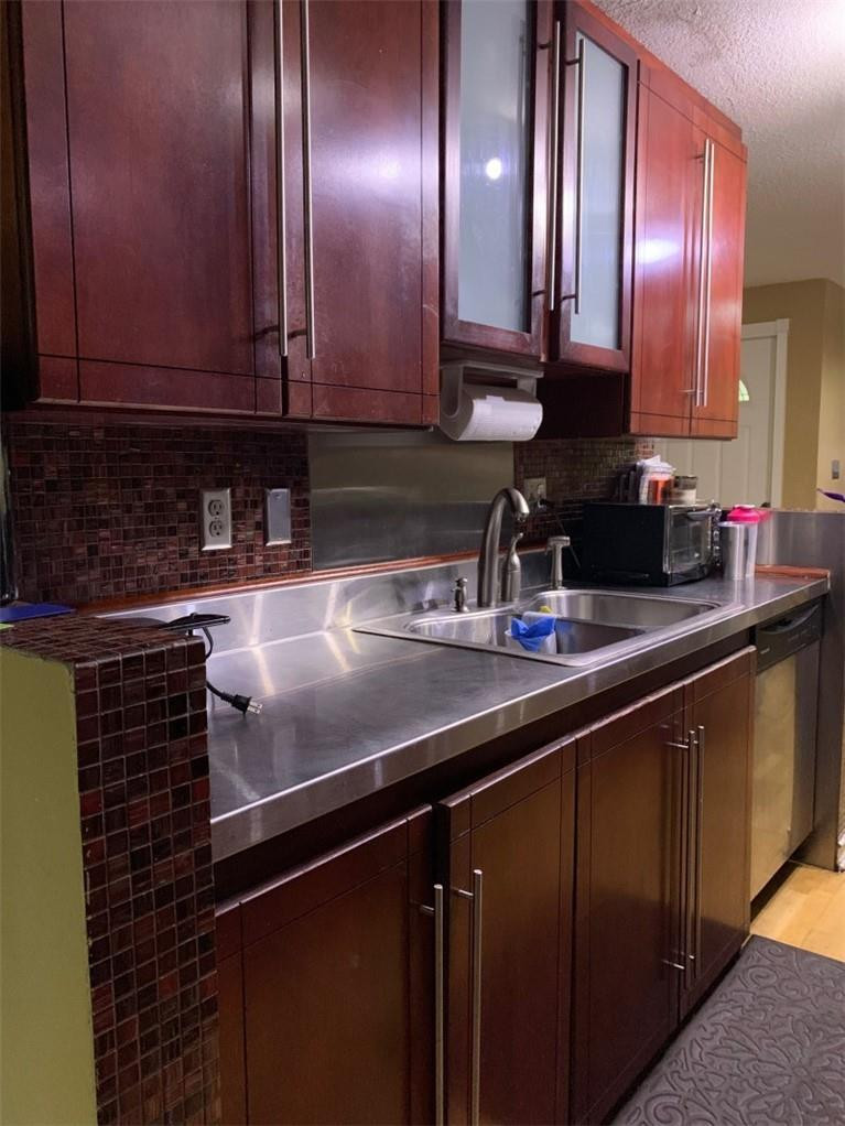 8244 9th Court, Unit 8 Plantation, FL 33324 - Photo 2 of 10 a kitchen with stainless steel appliances granite countertop a sink stove and cabinets