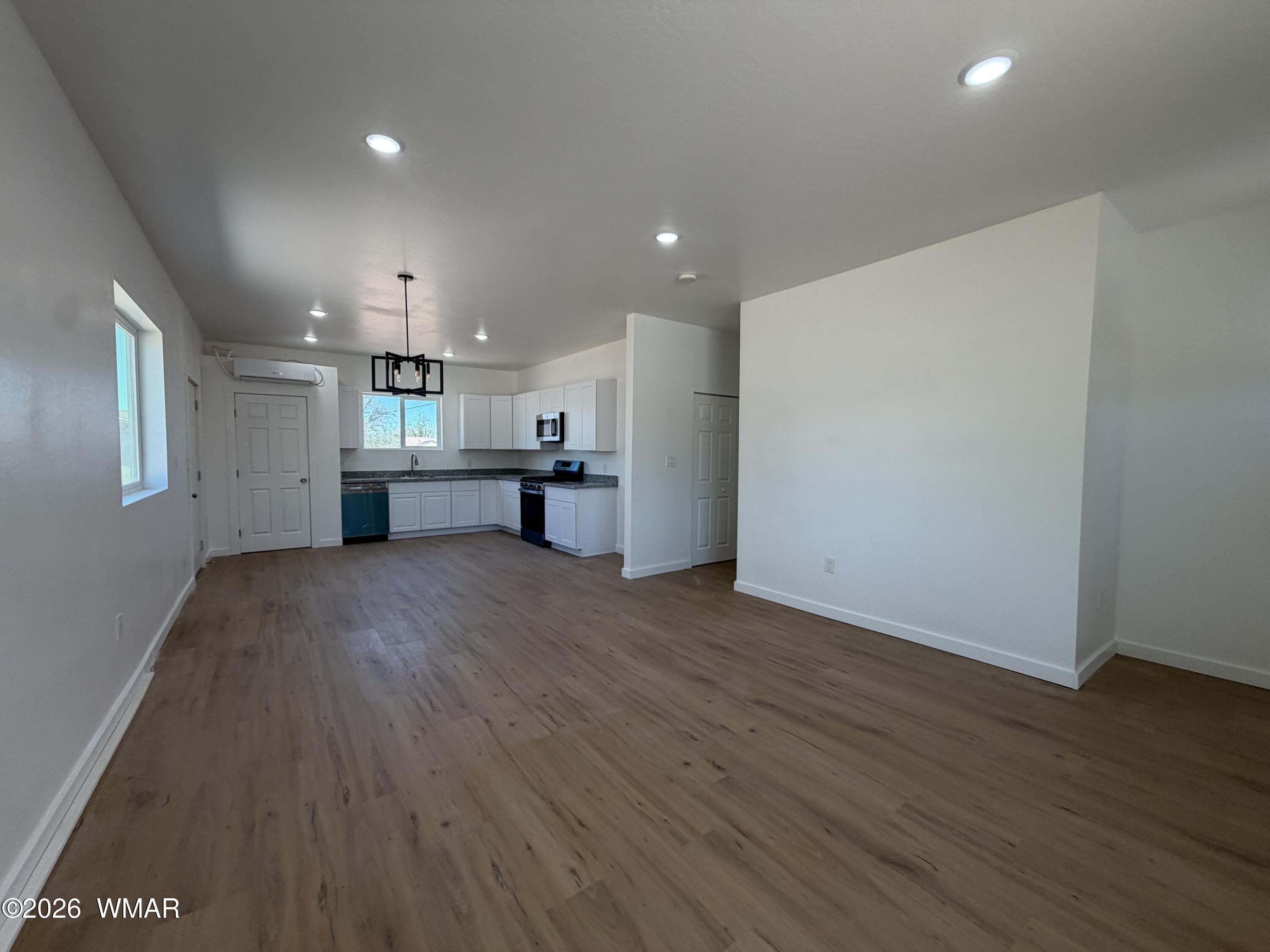 731 Tori Circle Springerville, AZ 85938 - Photo 5 of 19 a view of kitchen with refrigerator stove and wooden floor