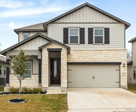 a view of a white house with large windows
