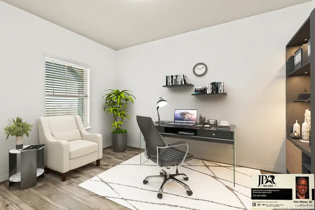 a view of a workspace with furniture and a window