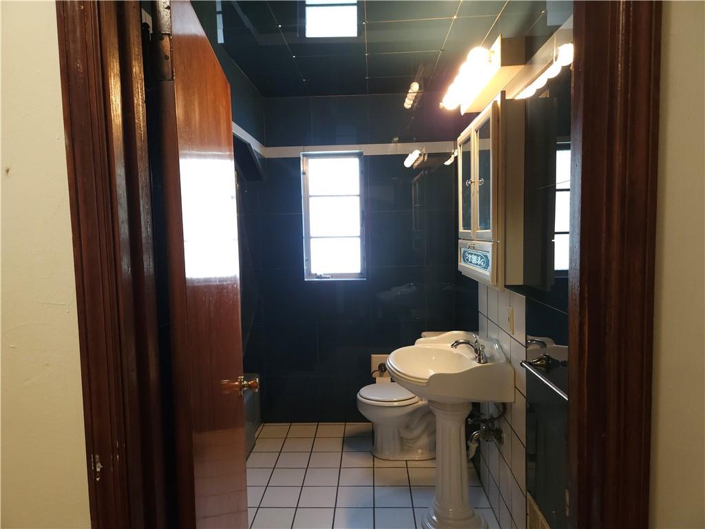 605 McCoy Road McKees Rocks, PA 15136 - Photo 27 of 39 a bathroom with a sink toilet and a mirror